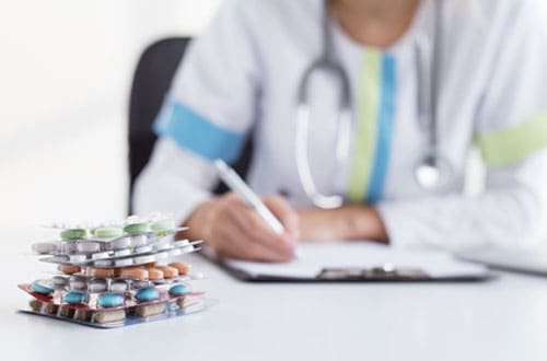 Doctor writing prescription for medicines