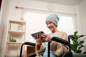 A young female patient with cancer, looking at a tablet | Navigating the rapidly changing oncology treatment landscape: how digital tools can help