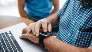 Elderly man looking at his wearable device