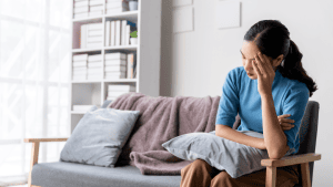 Woman with headache | It’s time to stop calling adverse events ‘manageable’