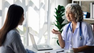 Doctor speaking to patient | Permission to pause: making treatment breaks part of the cancer care conversation