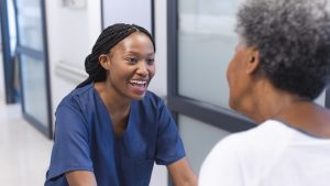 HCP engaging with elderly patient | Long-term clinical trial engagement is a behavioural challenge – not just an informational one