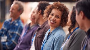 People smiling in meeting | Invited, but not equipped: patient involvement needs more than an open door